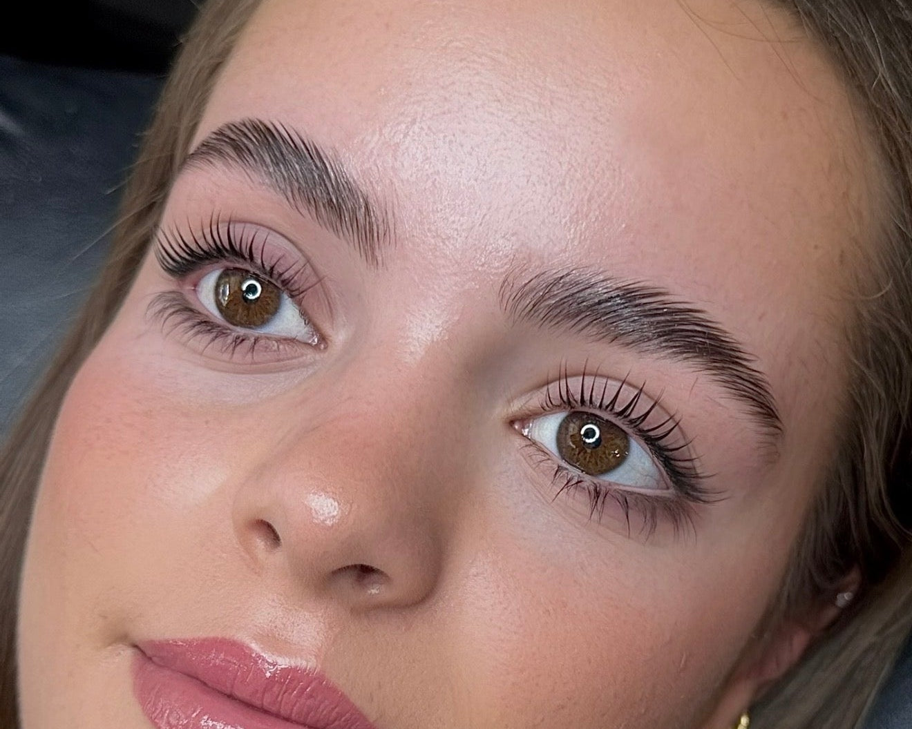 Close-up Korean lash lift showing glossy, lifted and defined natural lashes.